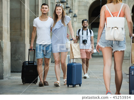 Adult man and woman in shorts with luggage Adult man and woman in shorts with luggage 45253934
