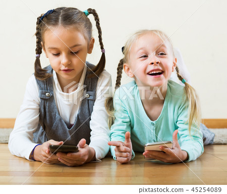 Girls playing online with phones 45254089