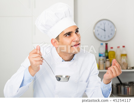 Person is evulating prepared soup Person is evulating prepared soup 45254117
