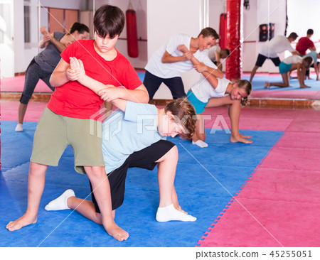 Kids exercising self-defense movements 45255051