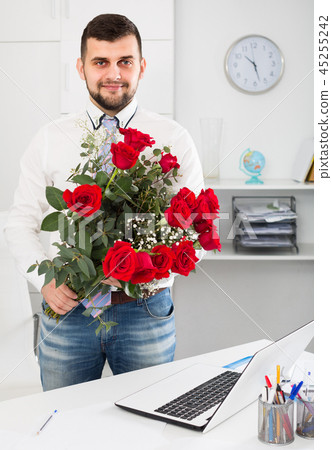 Male is presenting flowers and gift Male is presenting flowers and gift 45255242