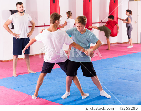 Kids practicing in pair self-protection Kids practicing in pair self-protection 45255289