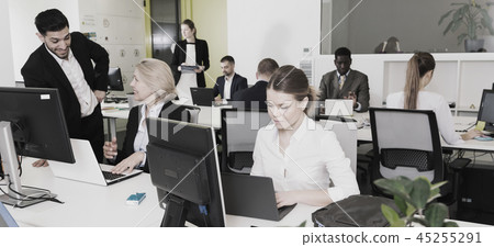 Business people working in open plan office 45255291
