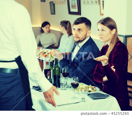 Dissatisfied young couple expressing dissatisfaction with food Dissatisfied young couple expressing dissatisfaction with food 45255293