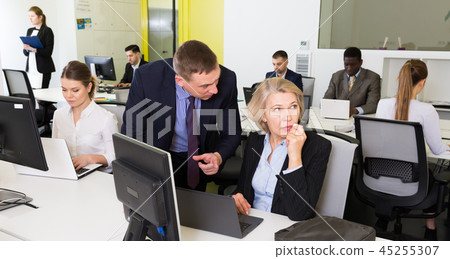 Upset mature woman with dissatisfied manager in coworking space Upset mature woman with dissatisfied manager in coworking space 45255307