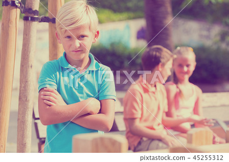 Portrait of boy 8-11 years old which is taking offense on his friends Portrait of boy 8-11 years old which is taking offense on his friends 45255312