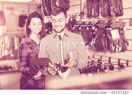 Couple deciding on protective gloves Couple deciding on protective gloves 45255387
