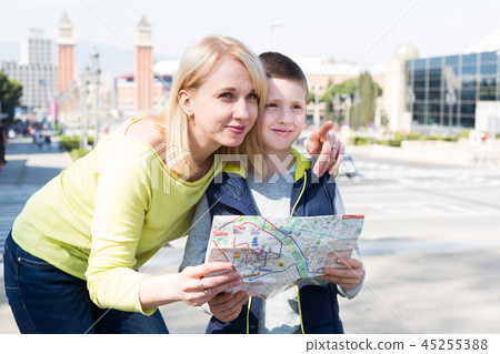 Mother and son reading map guide Mother and son reading map guide 45255388