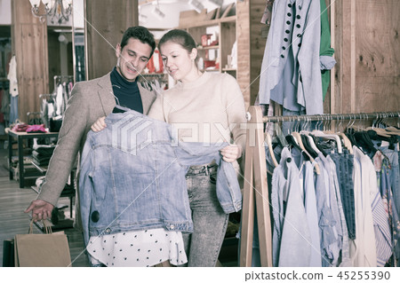 Couple is choosing jeans blouse for her Couple is choosing jeans blouse for her 45255390
