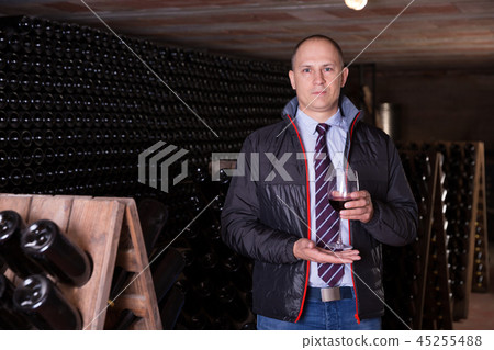 Winemaker offering red wine for tasting 45255488