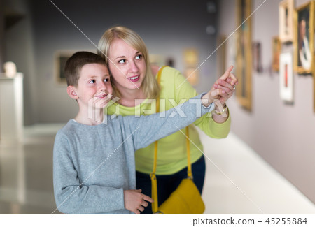 Smiling mom and son exploring paintings Smiling mom and son exploring paintings 45255884