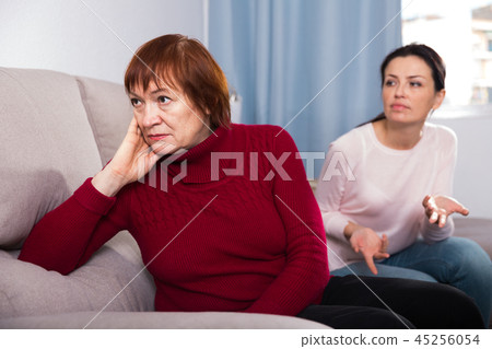Portrait upset adult women looking away after conflict Portrait upset adult women looking away after conflict 45256054