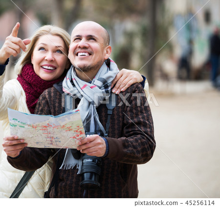 Mature spouses with paper map 45256114