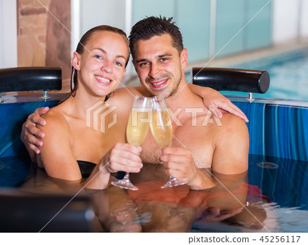 Romantic couple is relaxing with glasses of vine Romantic couple is relaxing with glasses of vine 45256117