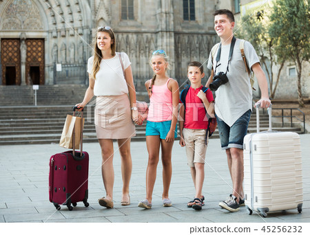 Happy parents with children travelling together on city 45256232