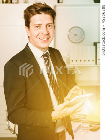 Man working and touching screen in the office Man working and touching screen in the office 45256889