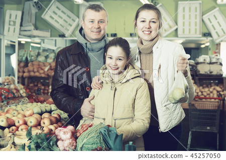 Family with purchases in fruit market 45257050