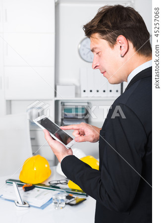 Man working and touching screen Man working and touching screen 45257068