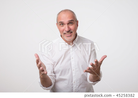 Inspired mature italian man expressing strong emotion while explaining something. Inspired mature italian man expressing strong emotion while explaining something. 45258382