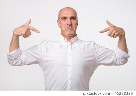 Man proud of himself over gray background. I am the best concept. Man proud of himself over gray background. I am the best concept. 45258389