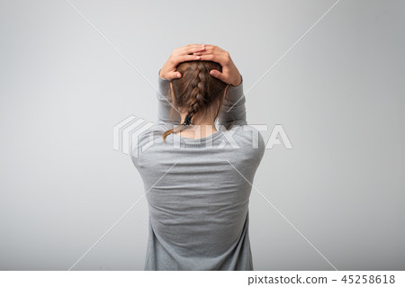 Crying standing young woman, back view Crying standing young woman, back view 45258618