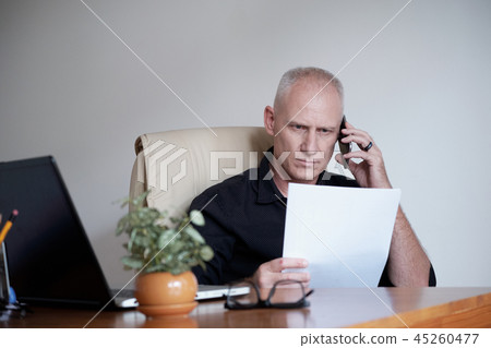 Businessman Working With Papers Businessman Working With Papers 45260477