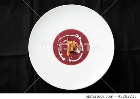 Top view of red cream soup with squid dish Top view of red cream soup with squid dish 45262215