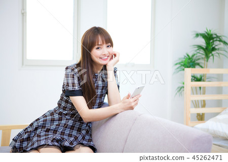 A woman touching a smartphone 45262471