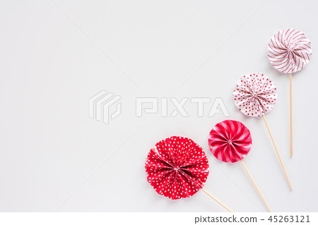 Red and white paper fan with wooden stick 45263121