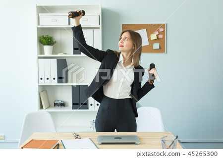 Office, fitness and people concept - Business woman working and doing sport at her office Office, fitness and people concept - Business woman working and doing sport at her office 45265300