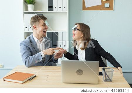 Business, break and people concept - Cheerful man and woman playing games in office while working Business, break and people concept - Cheerful man and woman playing games in office while working 45265344
