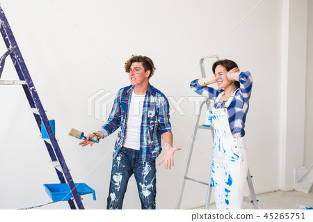 Conflict, repair and renovation concept - Young woman and man with annoying faces and bad emotions Conflict, repair and renovation concept - Young woman and man with annoying faces and bad emotions 45265751