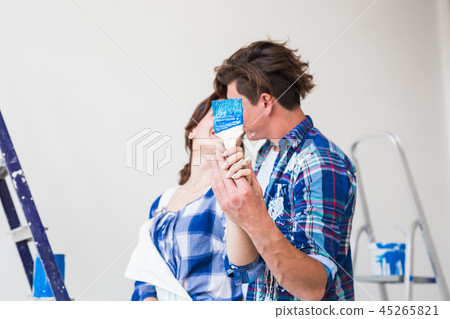 Renovation, repair and relationship concept - Young woman and man hugging each other Renovation, repair and relationship concept - Young woman and man hugging each other 45265821