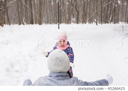 Family, children and nature concept - Mother with daughter have fun in the winter park 45266425