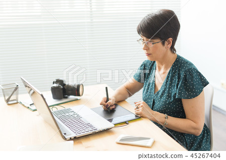 Business, web design and graphic art concept - middle-aged woman using pan sketch device 45267404