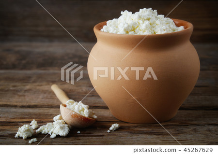 Cottage cheese in rustic vintage clay pot. 45267629