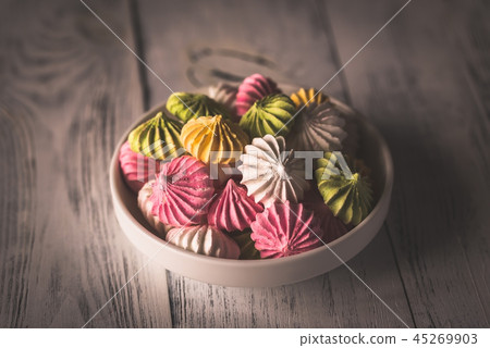Bowl of colored meringues 45269903