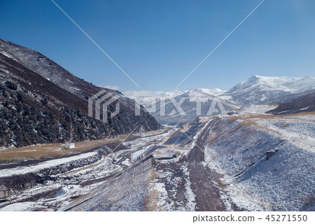 snowy pathway to mountain peak with clear blue sky snowy pathway to mountain peak with clear blue sky 45271550