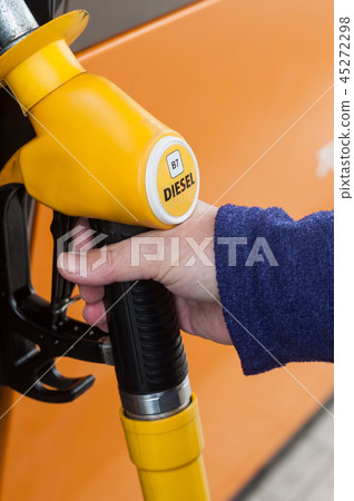 woman taking gas pistols in gas Station woman taking gas pistols in gas Station 45272298