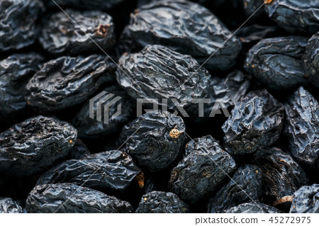 Black Raisin texture, popular dried fruit. Dried grapes. 45272975