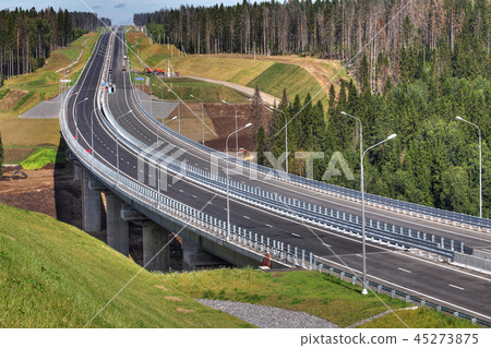 Top view of highway crossing forest, and bridge  45273875