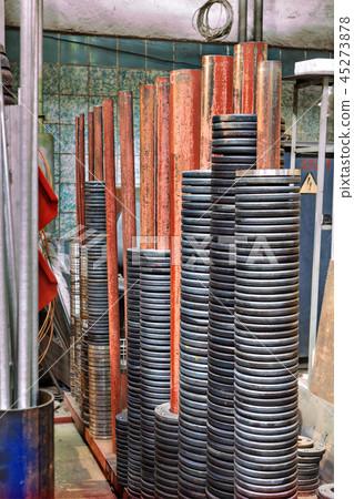 Steel discs on the spindle of a metal warehouse. Steel discs on the spindle of a metal warehouse. 45273878