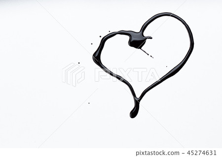 Nail polish on a white background in the form of a black heart 45274631