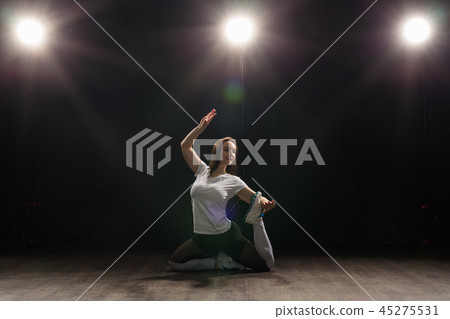 Dance, hip-hop, jazz funk and people concept - flexible young woman dancing in the darkness under 45275531