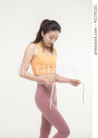 A Korean woman with a waist on a tape measure 45276281