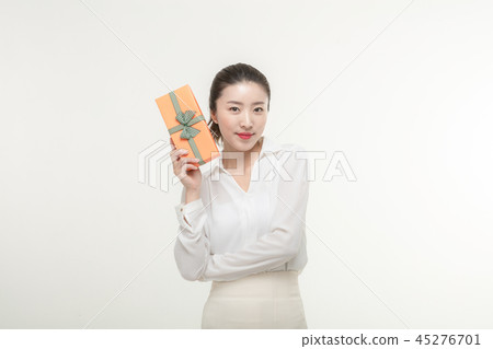 A woman who is delighted to receive a gift 45276701