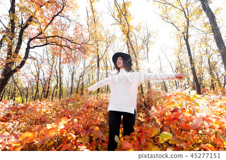 happy woman having fun in park on autumn sunny day. happy woman having fun in park on autumn sunny day. 45277151