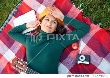 person lies on a blanket and dreamily looks up person lies on a blanket and dreamily looks up 45279639