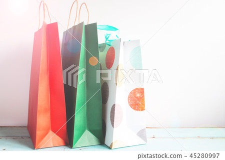 Colourful paper shopping bags on table with flare 45280997