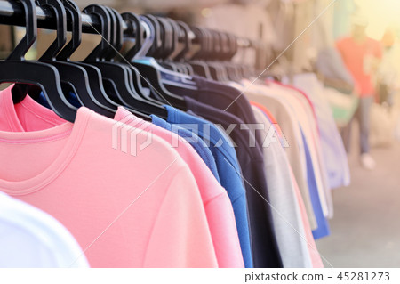 Colorful clothes hanging on clothesline and have orange sunlight shines. Colorful clothes hanging on clothesline and have orange sunlight shines. 45281273